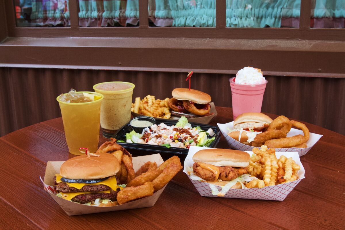 A fried chicken sandwich, salad, burgers, fries, onion rings, cocktails and a strawberry shake from Smokejumpers Grill