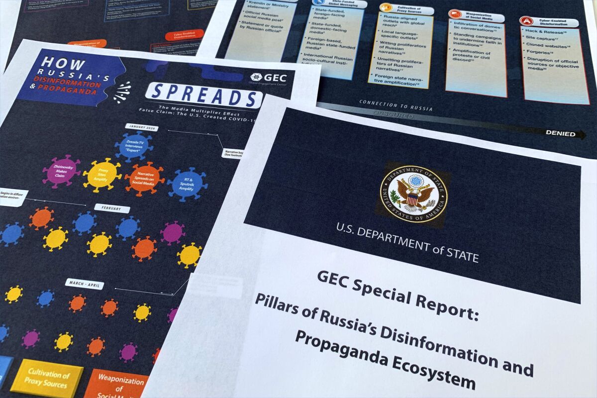 Pages from the U.S. State Department's Global Engagement Center report released on Aug. 5, 2020, are seen in this photo. Long before waging war on Ukraine, President Vladimir Putin was working to make Russia's internet a powerful tool of surveillance and social control akin to China's so-called Great Firewall. (AP Photo/Jon Elswick)