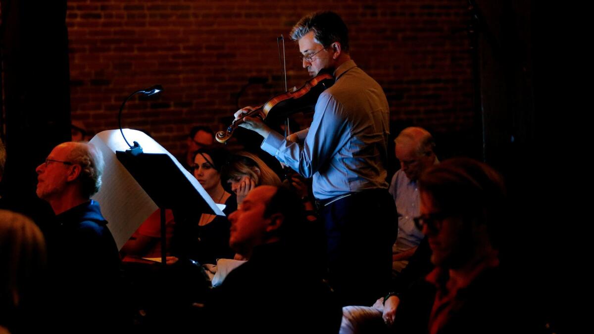 Mark Menzies performs "La Lontananza" at one of the music stands set up among audience members at Art Share L.A.