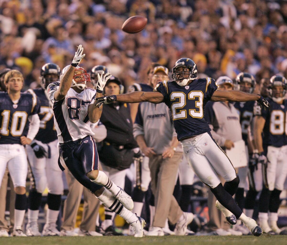 New England Patriots wide receiver Reche Caldwell catches pass over San Diego Chargers cornerback Quentin Jammer.