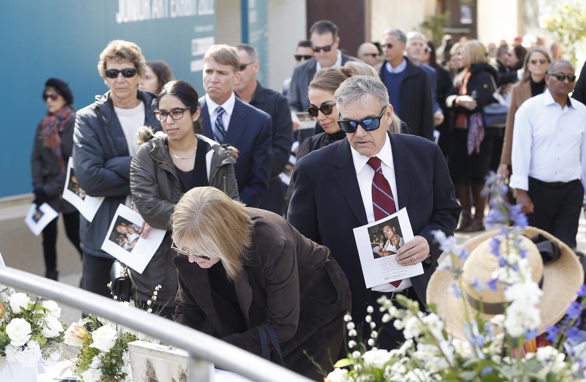 Guests arrive to pay their respects at the memorial ceremony for Dr. Michael Mammone.
