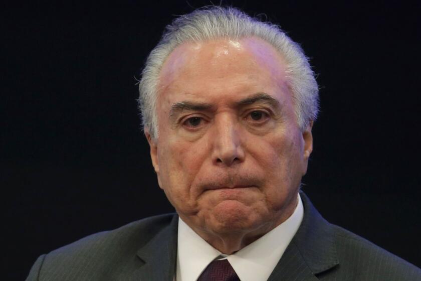 FILE - In this May 8, 2017, file photo, Brazil's President Michel Temer listens in during a event at the Brazilian Institute of Research in Brasilia, Brazil. Temer is denying a report that he endorsed the alleged bribing of a jailed former congressman to keep him quiet. The allegation made in a Globo News report on Wednesday, May 17, represents a potentially significant blow to President Temer. His administration has lurched from one crisis to another since he took office just over a year ago. (AP Photo/Eraldo Peres, File)