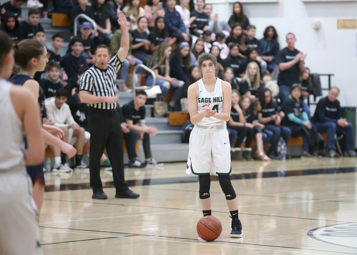 Sage Hill’s Isabel Gomez (24) puts the ball on the floor for a 24-second violation in honor of Kobe Bryant before a San Joaquin League game on Tuesday.