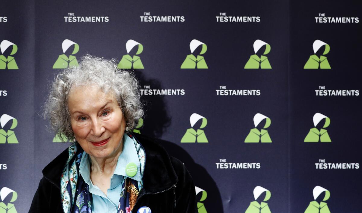 FILE - In this Tuesday, Sept. 10, 2019 file photo, Canadian author Margaret Atwood poses for a photograph during a press conference at the British Library to launch her new book 'The Testaments' in London. Booker Prize winner Margaret Atwood is the bookies' favorite to win the coveted fiction trophy again for "The Testaments," her follow-up to dystopian saga "The Handmaid's Tale." Atwood is one of six finalists for the 50,000-pound ($63,000) prize, whose winner will be announced Monday Oct. 14, 2019. (AP Photo/Alastair Grant, File)