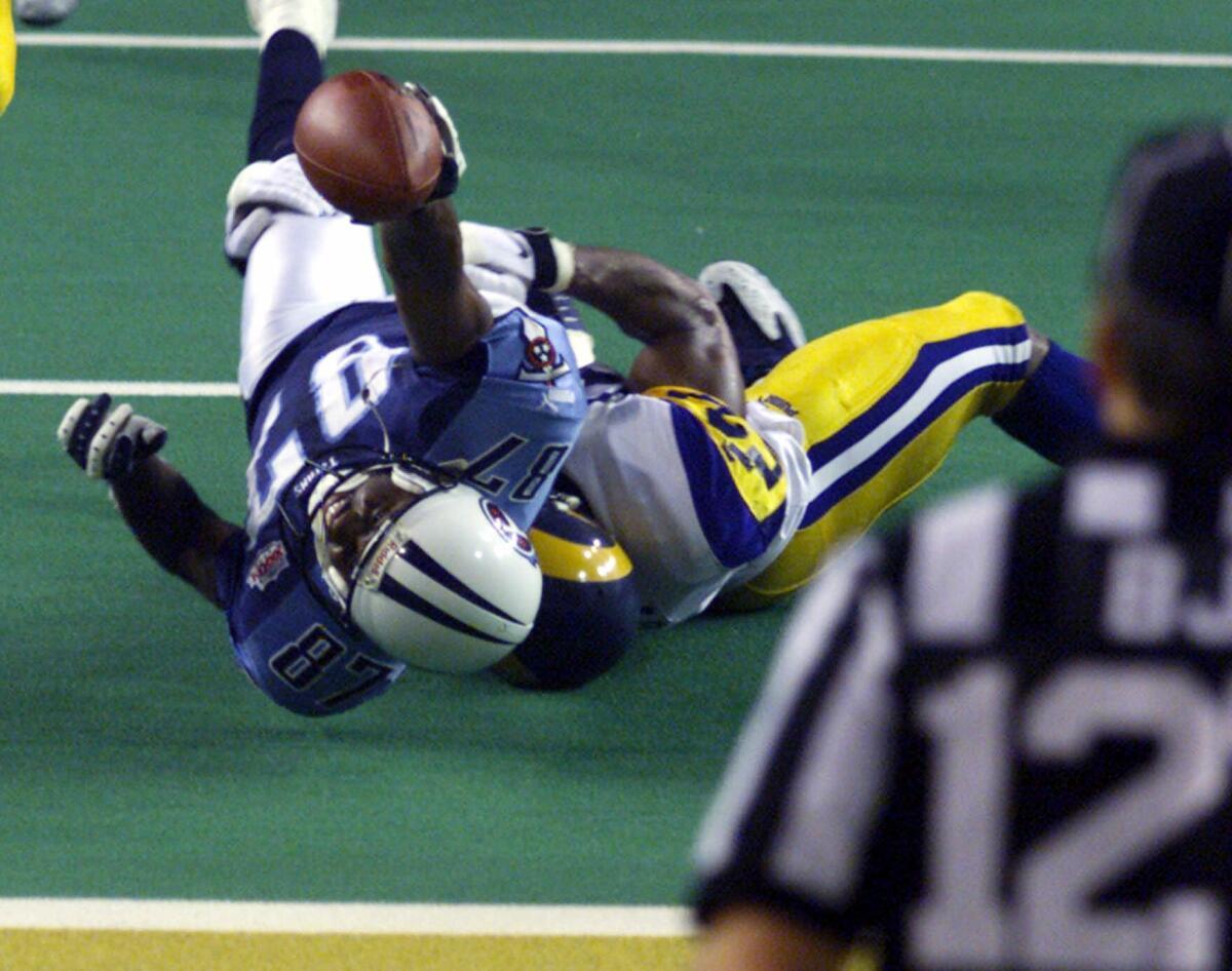 FILE - In this Jan. 30, 2000, file photo, Tennessee Titans wide receiver Kevin Dyson (87) is tackled short of the goal line by St. Louis Rams linebacker Mike Jones on the final play of NFL football's Super Bowl XXXIV to preserve the Rams' 23-16 win in Atlanta. (AP Photo/Michael Conroy, File)