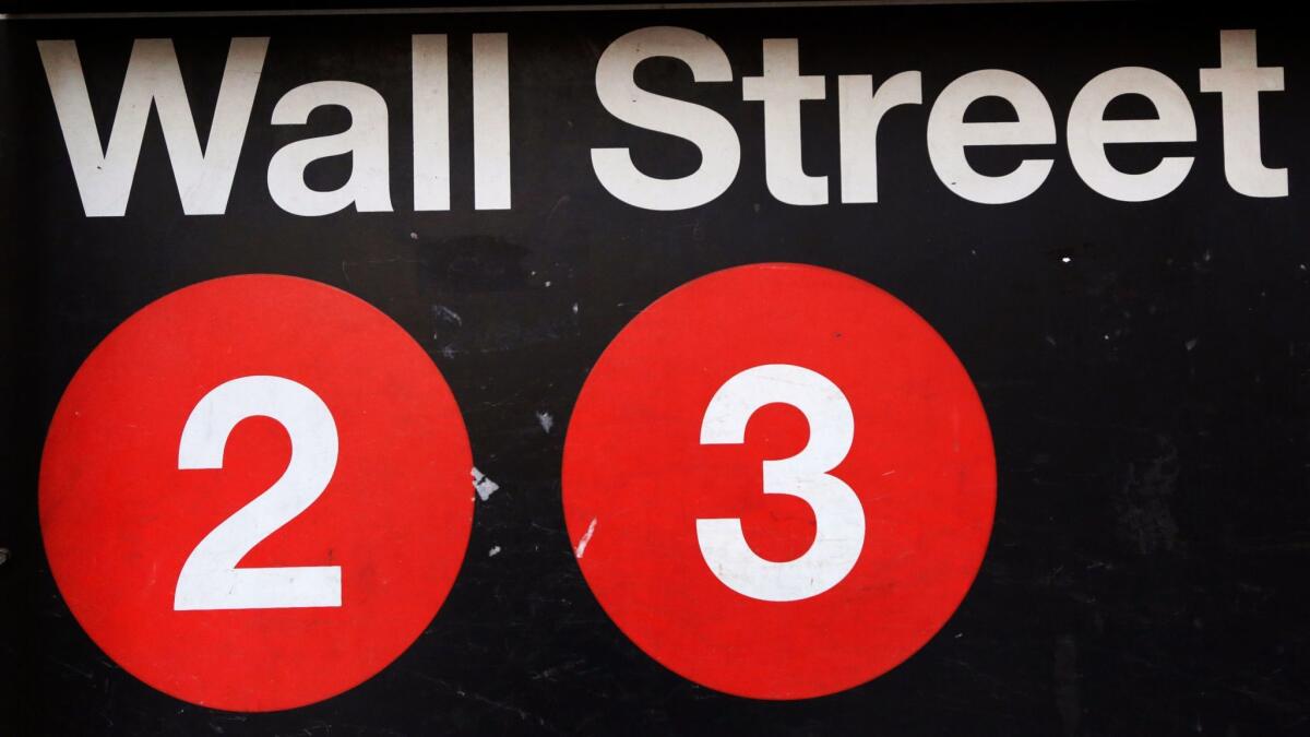 A sign for a Wall Street subway station in New York.