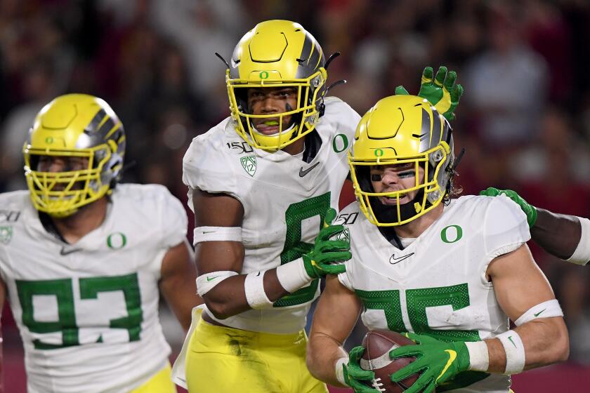 LOS ANGELES, CALIFORNIA - NOVEMBER 02: Brady Breeze #25 of the Oregon Ducks celebrates his touchdown from his interception with Jevon Holland #8 and Sione Kava #93, to take a 21-10 lead over the USC Trojans, during the first half at Los Angeles Memorial Coliseum on November 02, 2019 in Los Angeles, California. (Photo by Harry How/Getty Images)