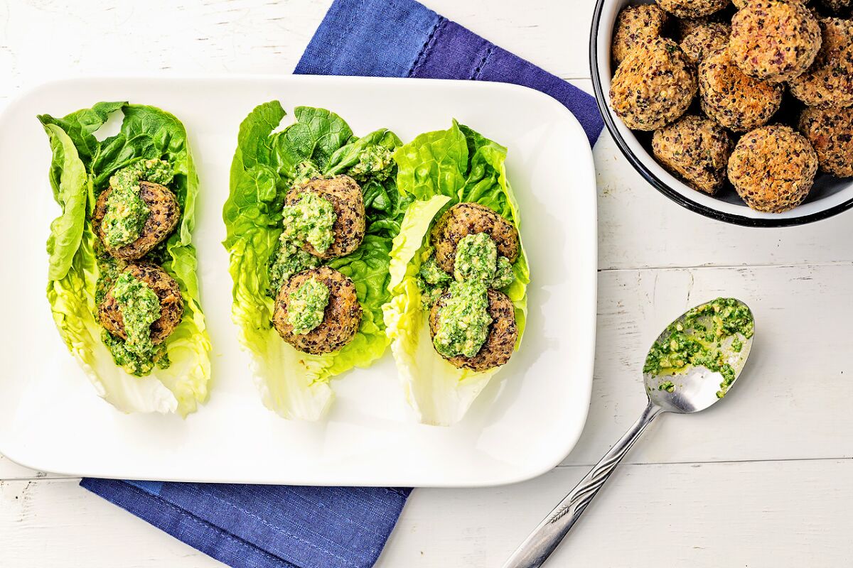 Quinoa balls topped with lemony walnut pesto and wrapped in beautiful gem lettuce.