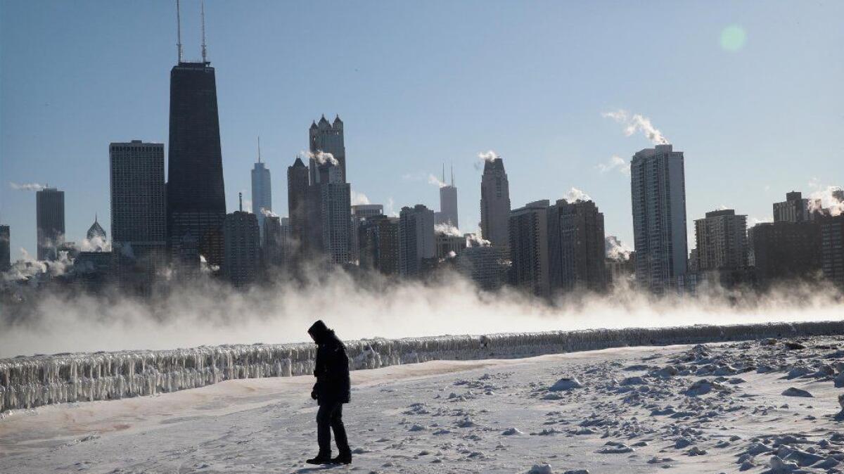 A man walks along Lake Michigan as temperatures in Chicago hover around 20 degrees below zero on Jan. 30.