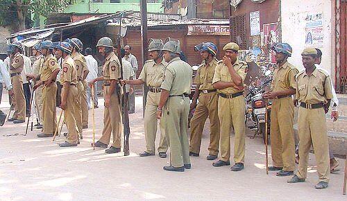 Indian police stand alert outside
