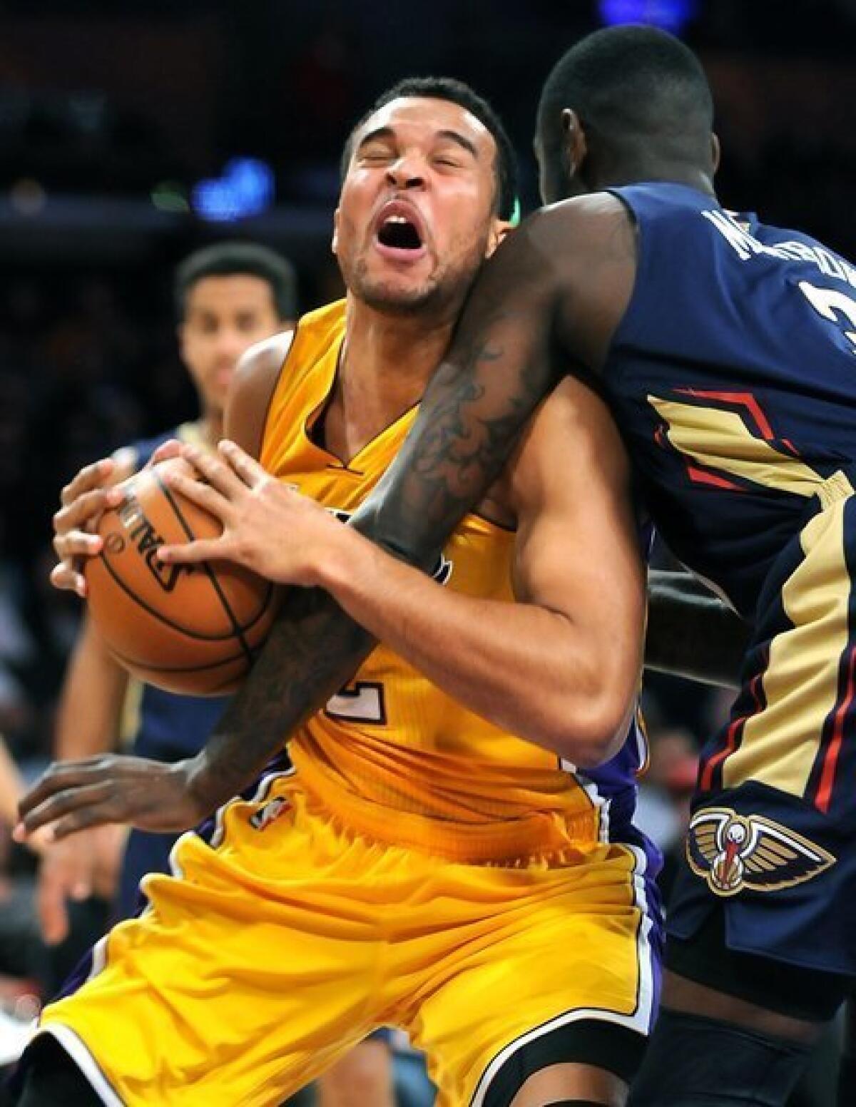 The Lakers' Elias Harris is fouled by the Pelicans' Anthony Morrow while driving to the basket during the Lakers' 116-95 victory over New Orleans on Tuesday at Staples Center.