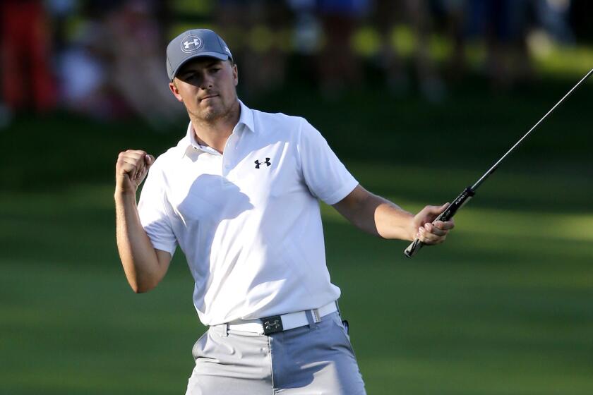 Jordan Spieth celebrates after making a birdie putt on the 18th hole to finish off a round of 61 on Saturday at the John Deere Classic.