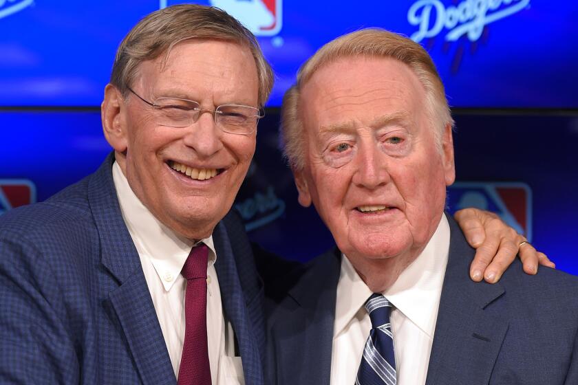 Outgoing MLB Commissioner Bud Selig, left, poses with Dodgers announcer Vin Scully before a game between the Dodgers and Arizona Diamondbacks in September.