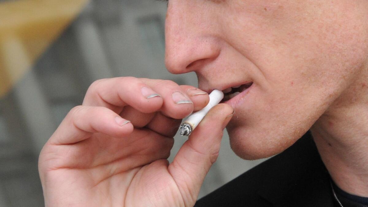 A man smokes a cigarette in Washington, D.C. The prevalence of smoking in the nation's capital ranges from about 9% in some neighborhoods to nearly 50% in others, researchers found.