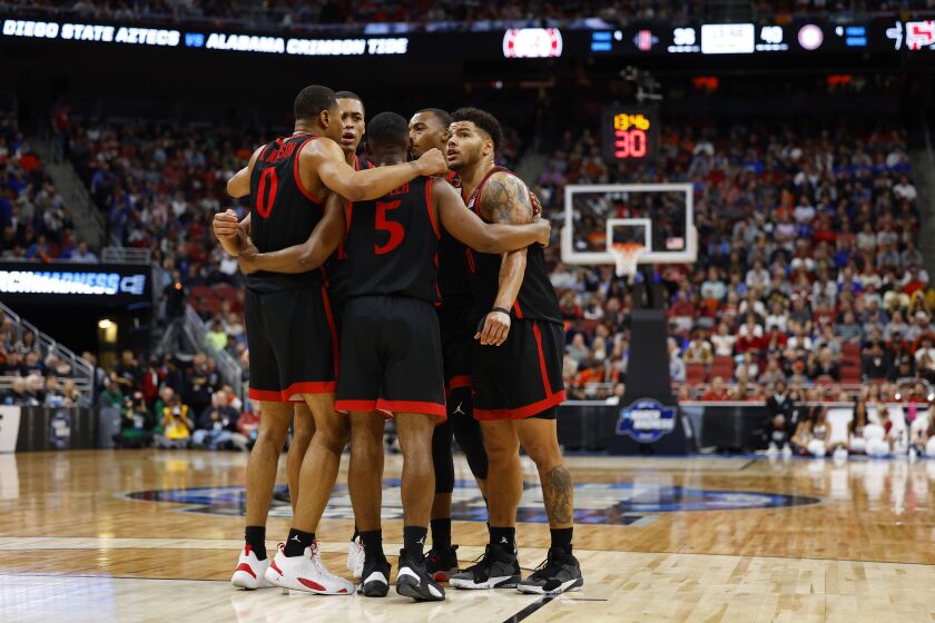Louisville, KY - March 24: San Diego State gathers on the court during a win against Alabama in a Sweet 16 game in the NCAA Tournament on Friday, March 24, 2023 in in Louisville, KY. (K.C. Alfred / The San Diego Union-Tribune)