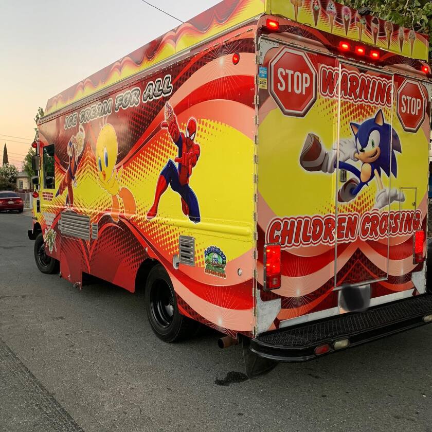 An ice cream truck with cartoon character graphics on it