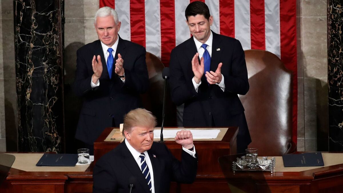 President Donald Trump, backed by Vice President Mike Pence, left, and House Speaker Paul Ryan of Wisconsin, addresses Congress in Washington on Feb. 28.