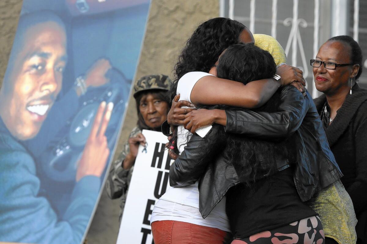 Relatives and neighbors gather for a prayer vigil for Dominique Austin, seen in the photo at left, who was killed on March 31 in Inglewood. Austin's good friend Tyrone Koger had been killed four years earlier just 3 miles from where Austin was gunned down.