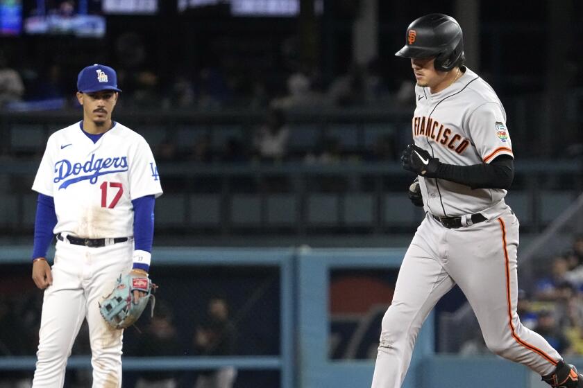 San Francisco Giants' Wilmer Flores, right, rounds second after hitting a two-run home run.