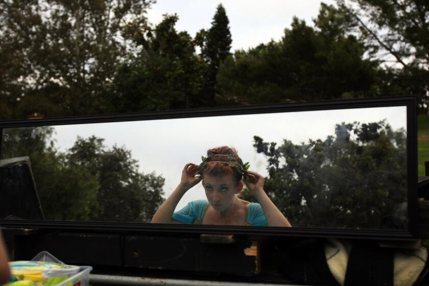 A reflection in a mirror as Olivia Schlueter-Corey prepares herself to play Hermia in "A Midsummer Night's Dream" by Shakespeare by the Sea in Polliwog Park in Manhattan Beach on Aug. 9, 2014.