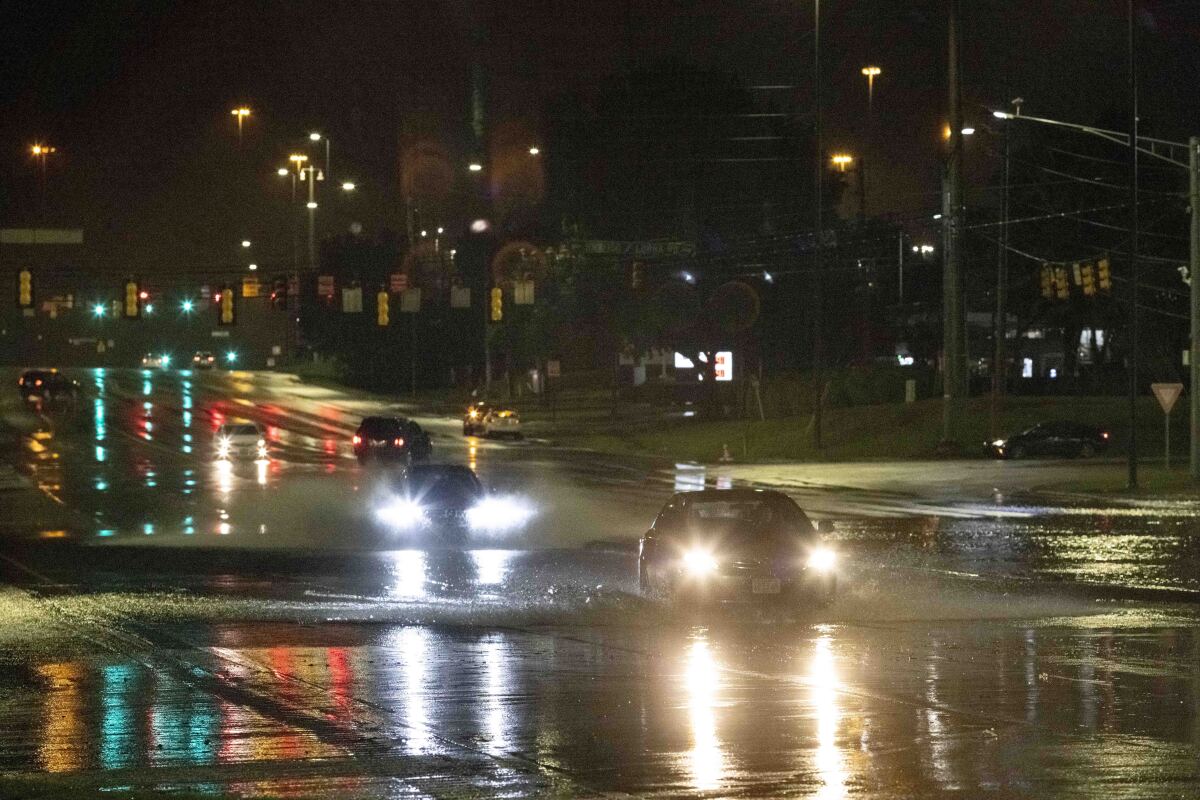 Car travel through floodwaters on Montgomery highway Wednesday, Oct. 6, 2021, near the Riverchase Galleria complex in Birmingham, Ala. (AP Photo/Vasha Hunt)