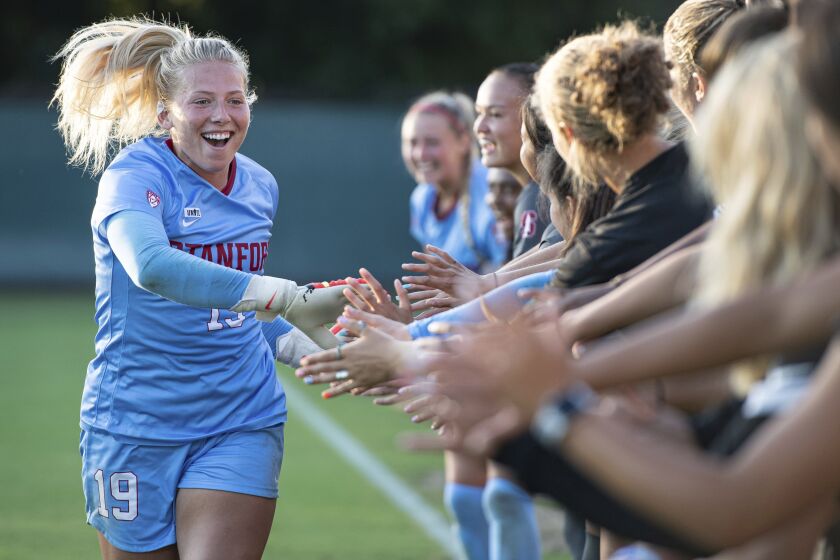 In a photo provided by Stanford Athletics, Stanford goalkeeper Katie Meyer shakes hands with teammates before a game against Cal State Northridge on Aug. 26, 2021, in Stanford, Calif. Meyer, who memorably led the Cardinal to victory in the 2019 NCAA College Cup championship game, had died. She was 22. The cause of death was not released. Stanford first announced the death of a student at one of its residence halls on Monday, Feb. 28, 2022. On Tuesday, the university confirmed it was Meyer, a senior international relations major. (Lyndsay Radnedge/Stanford Athletics via AP)