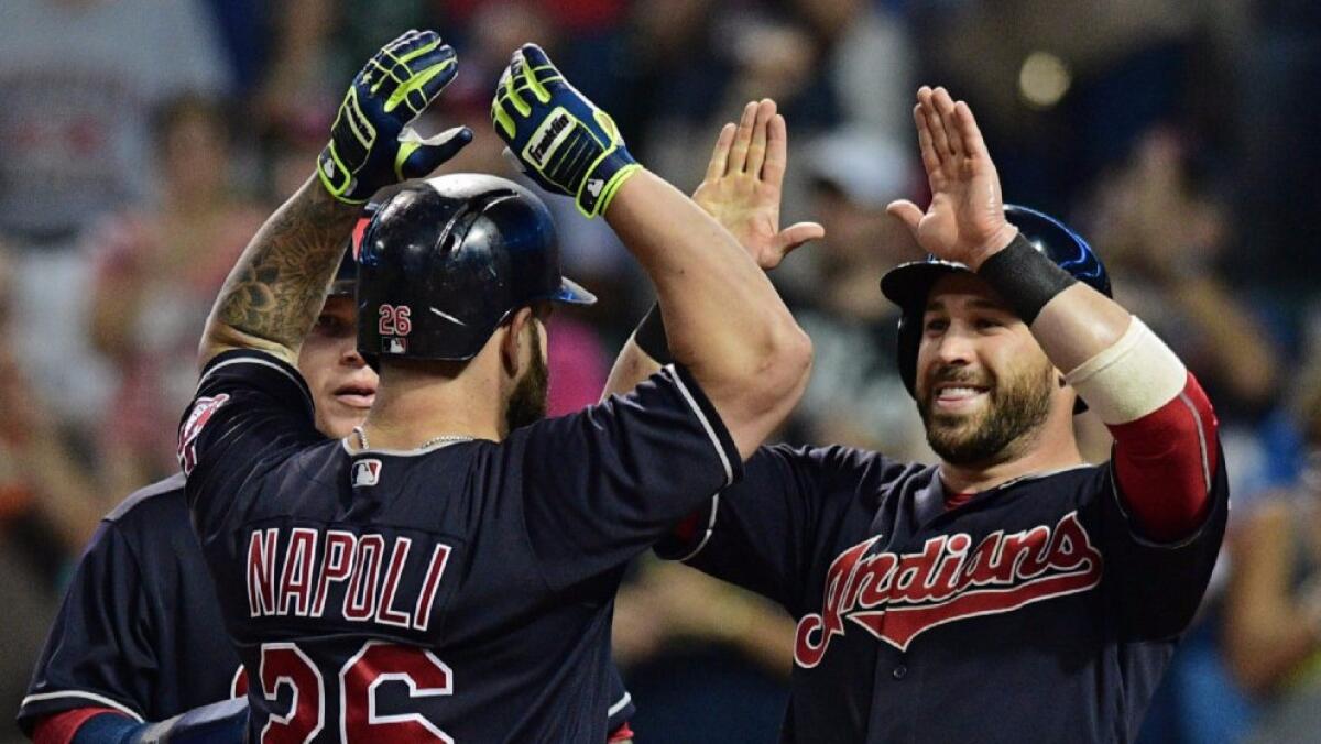 Mike Napoli celebrates with Jason Kipnis, right, and Roberto Perez, left, after hitting a three-run home run during the fifth inning of a game against the Angels in Cleveland on Aug 11.