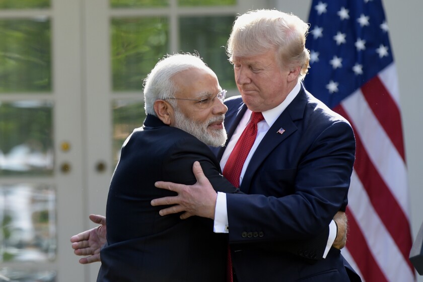 FILE - In this June 26, 2017, file photo, President Donald Trump and Indian Prime Minister Narendra Modi hug while making statements in the Rose Garden of the White House in Washington. Officials in the U.S. and Indian governments say President Donald Trump is in the early stages of planning what would be his first visit to India, the world's largest democracy. (AP Photo/Susan Walsh, File)