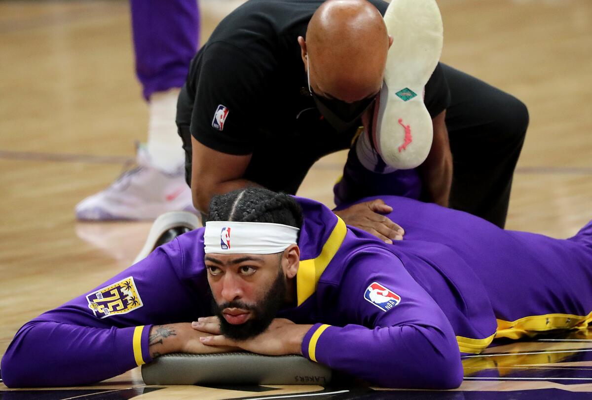 Anthony Davis stretches out before a loss to the Clippers on April 5.