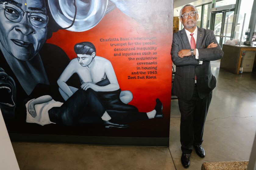 Los Angeles, CA - May 18: Councilmember Curren Price poses for a portrait with a mural depicting history of the Zoot Suit riots inside offices near the Central Avenue Farmer's Market on Thursday, May 18, 2023 in Los Angeles, CA. (Dania Maxwell / Los Angeles Times).
