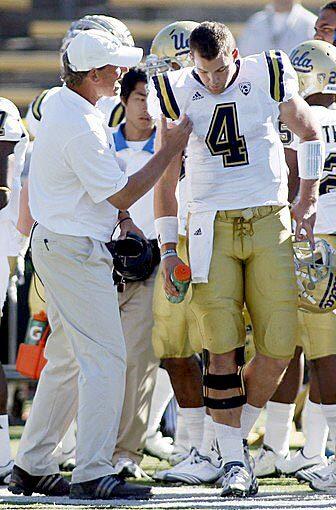 UCLA Coach Rick Neuheisel talks to quarterback Kevin Prince in the final moments of a 35-7 loss to California on Saturday at Memorial Stadium in Berkeley.