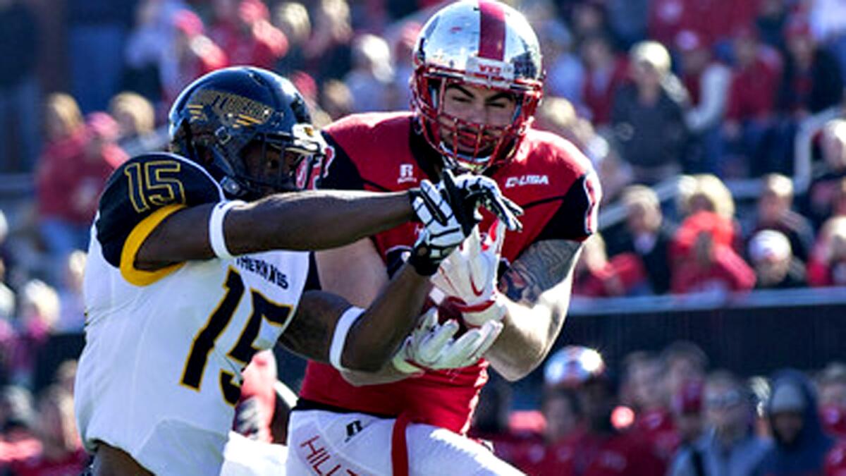 Western Kentucky tight end Tyler Higbee, right, makes a catch despite tight coverage by Southern Mississippi's Deviant Foster during the CUSA championship game on Dec. 5, 2015.