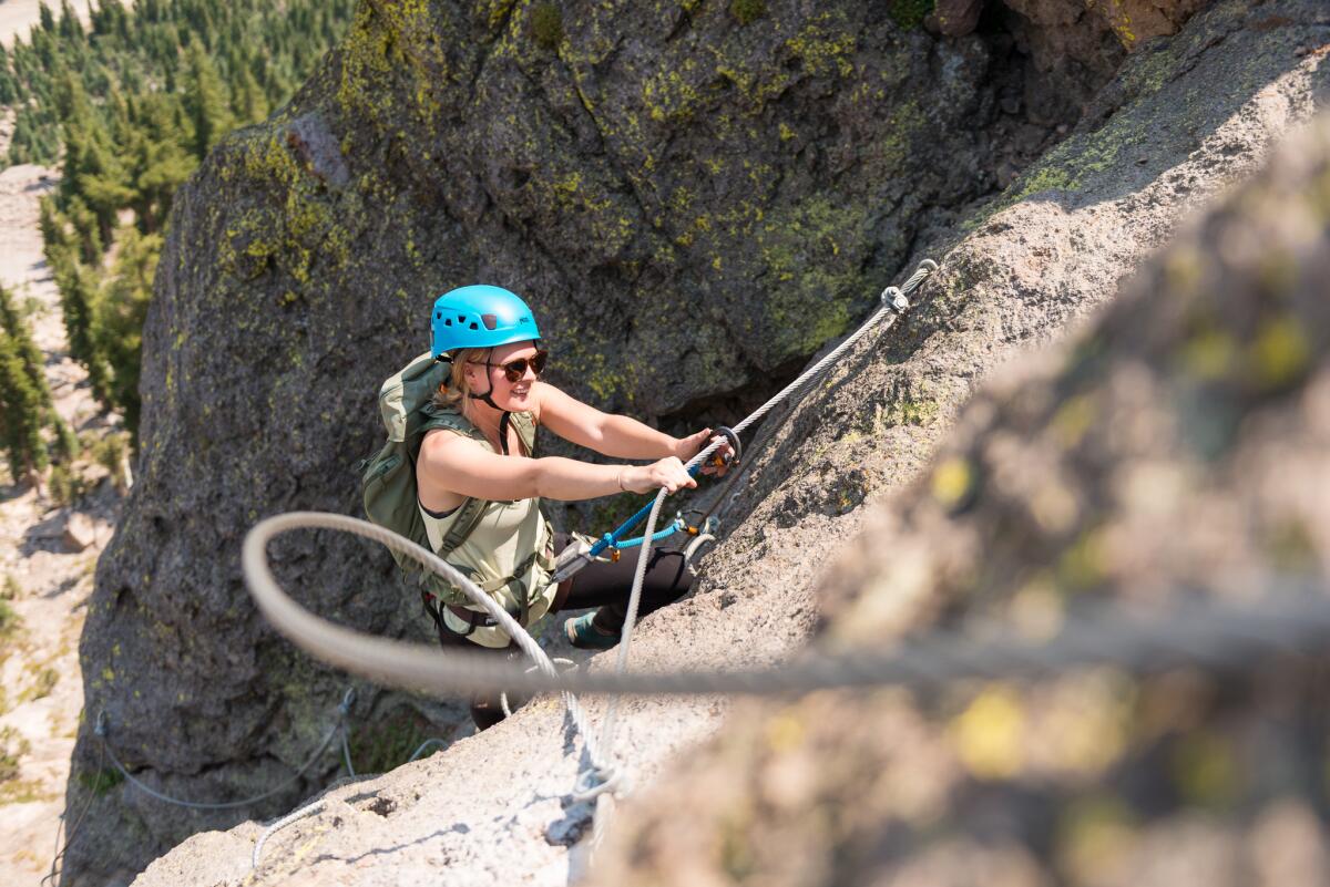 A woman climbs a rockface at Mammoth Mountain's Adventure Center.