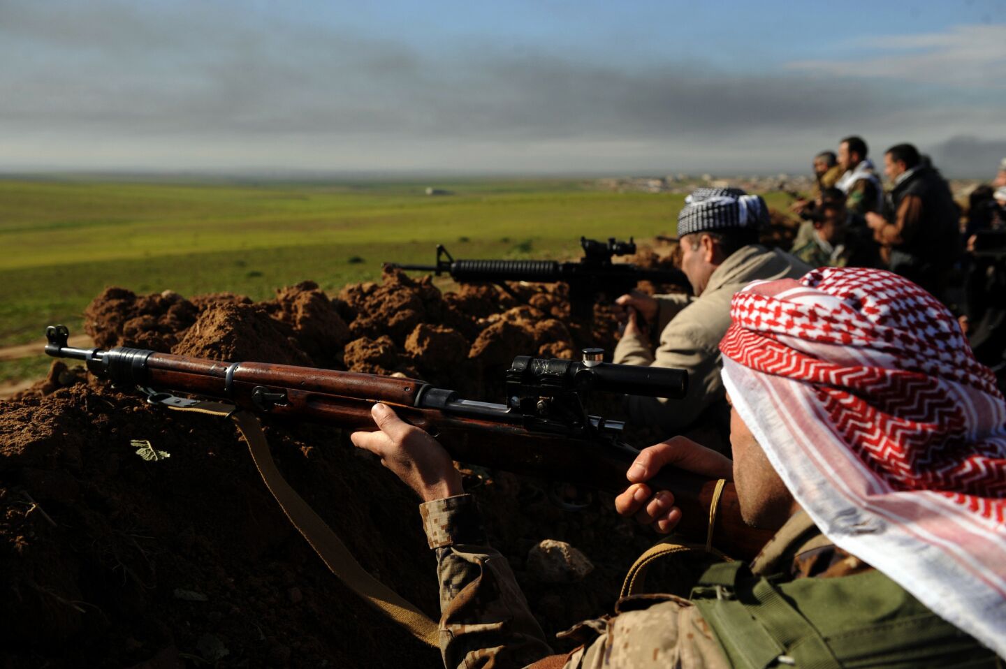 Peshmerga fighters take aim at Islamic State militants near Mosul, Iraq last month.