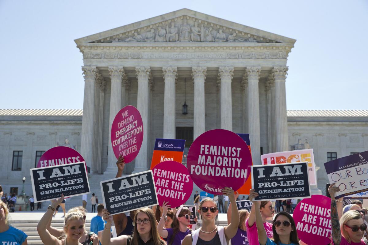Demonstrators on both sides of the abortion issue stand in front of the Supreme Court in Washington, D.C., on Monday, June 20, 2016, as the court announced several decisions.