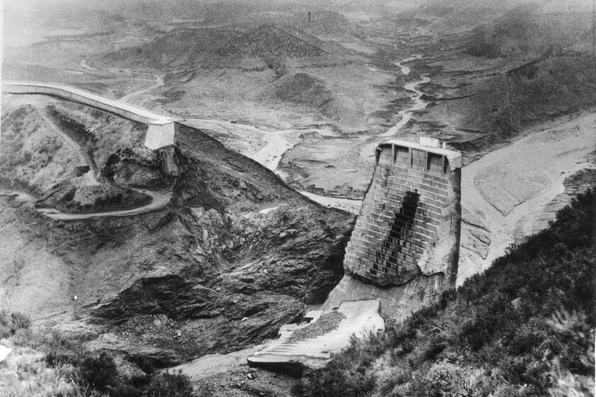 20030209 (LA/B5,SF/B5) –– DEVASTATION: The St. Francis Dam after it collapsed and sent a 10–story wall of water through San Francisquito Canyon. 20030209 (VN/B3) –– AFTER: The dam after it collapsed in 1928, sending a 10–foot wall of water roaring through San Francisquito Canyon. 00–10–14(Valley) –– (2 Photos) The St. Francis Dam, above left, was completed in 1926 and held water brought south in the L.A. Aqueduct. Above right, the dam shortly after it collapsed in 1928, killing more than 450 people. 98–03–08 (Ventura) –– Little was left after the St. Francis Damcollapsed, sendingbillions of gallons of water down San Francisquito Canyon. FILE PHOTO This is all that was left of the St. Francis dam in San Francisquito canyon after it collapsed in 1928.