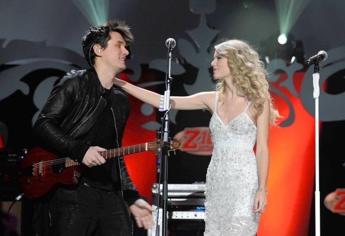 John Mayer and Taylor Swift perform during Z100's Jingle Ball 2009 at Madison Square Garden in New York City.