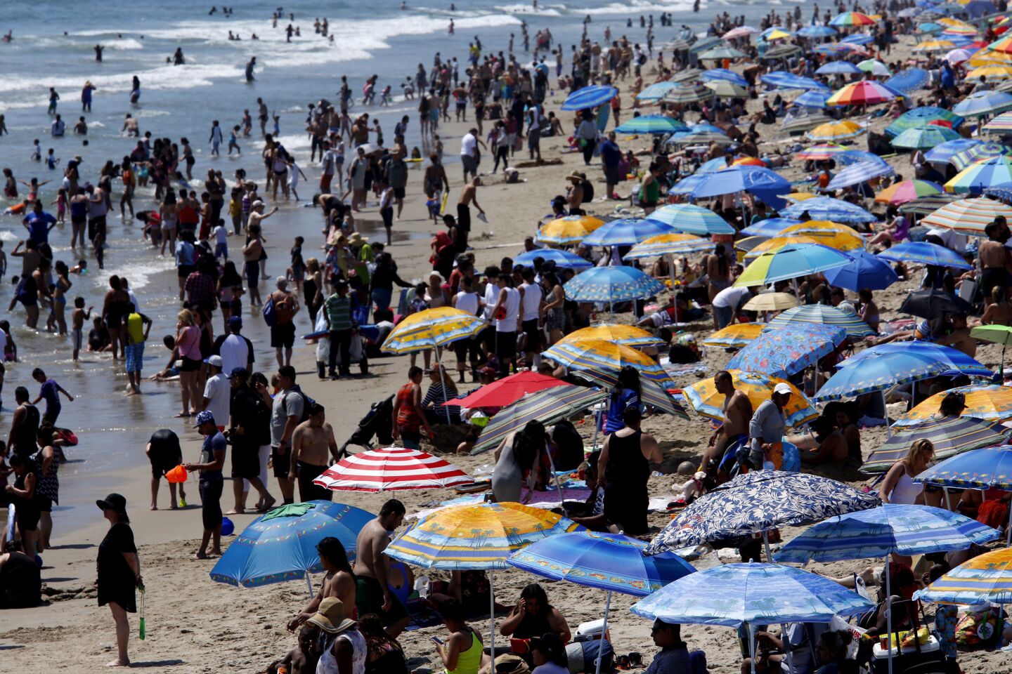 With temperatures soaring, crowds flock to the beach on the north side of the Santa Monica Pier in Santa Monica.