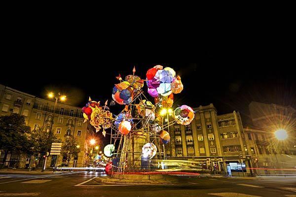 This colorful display in Chile Square, designed by artist Catarina Pestana, is crafted out of umbrellas. From afar, the umbrellas look like holiday ornaments.