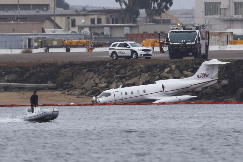 SAN DIEGO, CA - SEPTEMBER 9: Emergency crews are investigating after a Learjet 36 crash-landed into an embankment along the shoreline at Naval Air Station North Island on Friday, base officials said. The hard landing happened about 1:15 p.m. at the end of runway 18 at Halsey Field Airport, which is on base, said spokesman Kevin Dixon on on Friday, September 9, 2022. (K.C. Alfred / The San Diego Union-Tribune)