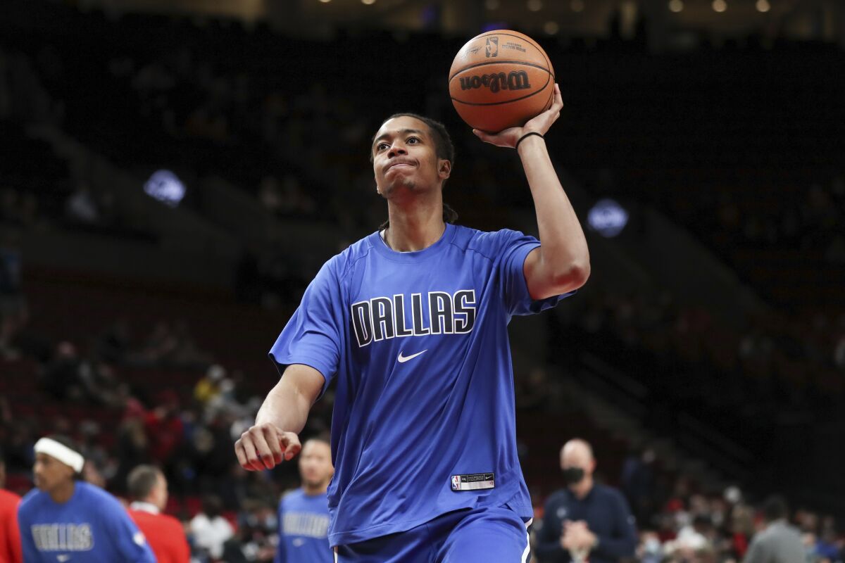 FILE - Dallas Mavericks center Moses Brown warms up prior to an NBA basketball game against the Portland Trail Blazers in Portland, Ore., Wednesday, Jan. 26, 2022. With All-Star center Jarrett Allen sidelined indefinitely with a broken finger, the Cleveland Cavaliers signed big man Moses Brown to a 10-day contract on Thursday, March 10, 2022. (AP Photo/Amanda Loman, File)