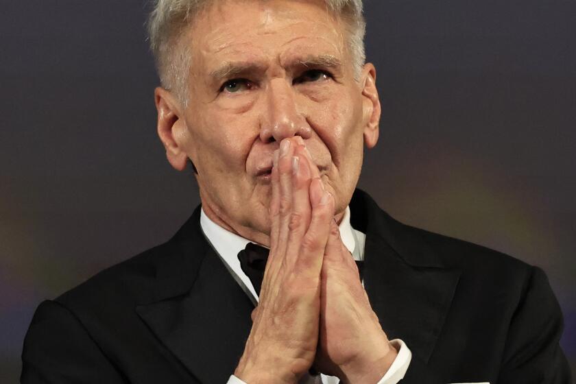 US actor Harrison Ford reacts on stage before being awarded with an Honourary Palme d'or prior to the screening of the film "Indiana Jones and the Dial of Destiny" during the 76th edition of the Cannes Film Festival in Cannes, southern France, on May 18, 2023. (Photo by Valery HACHE / AFP) (Photo by VALERY HACHE/AFP via Getty Images)