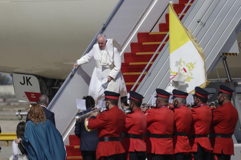 Pope Francis arrives at Baghdad's international airport, Iraq, Friday, March 5, 2021. Pope Francis heads to Iraq on Friday to urge the country's dwindling number of Christians to stay put and help rebuild the country after years of war and persecution, brushing aside the coronavirus pandemic and security concerns. (AP Photo/Andrew Medichini)