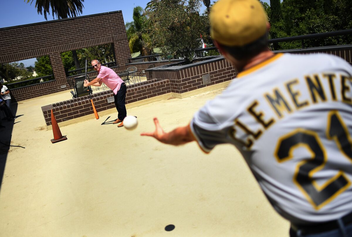 Jon Leonoudakis pitches to Stephen Dolainski, a friend of an Alzheimer’s patient, during a meeting in Los Angeles held by BasebALZ.