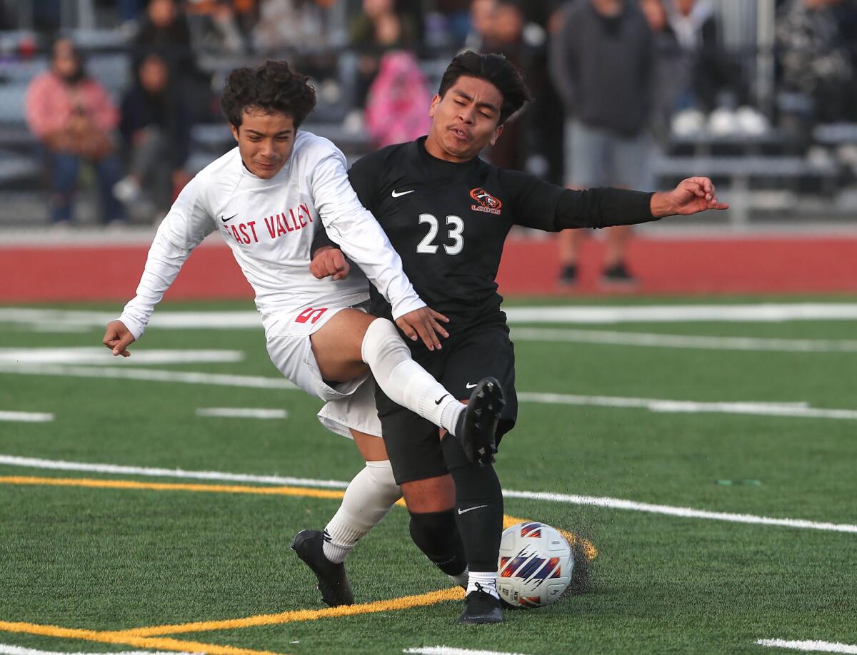 Los Amigos' Peter Hernandez (23) stops the dribble of Redlands East Valley's Omario Gonzalez on Wednesday.