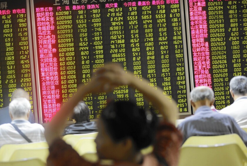 Investors monitor data at a securities brokerage house in Beijing. In China, the biggest investor by far remains the government itself.