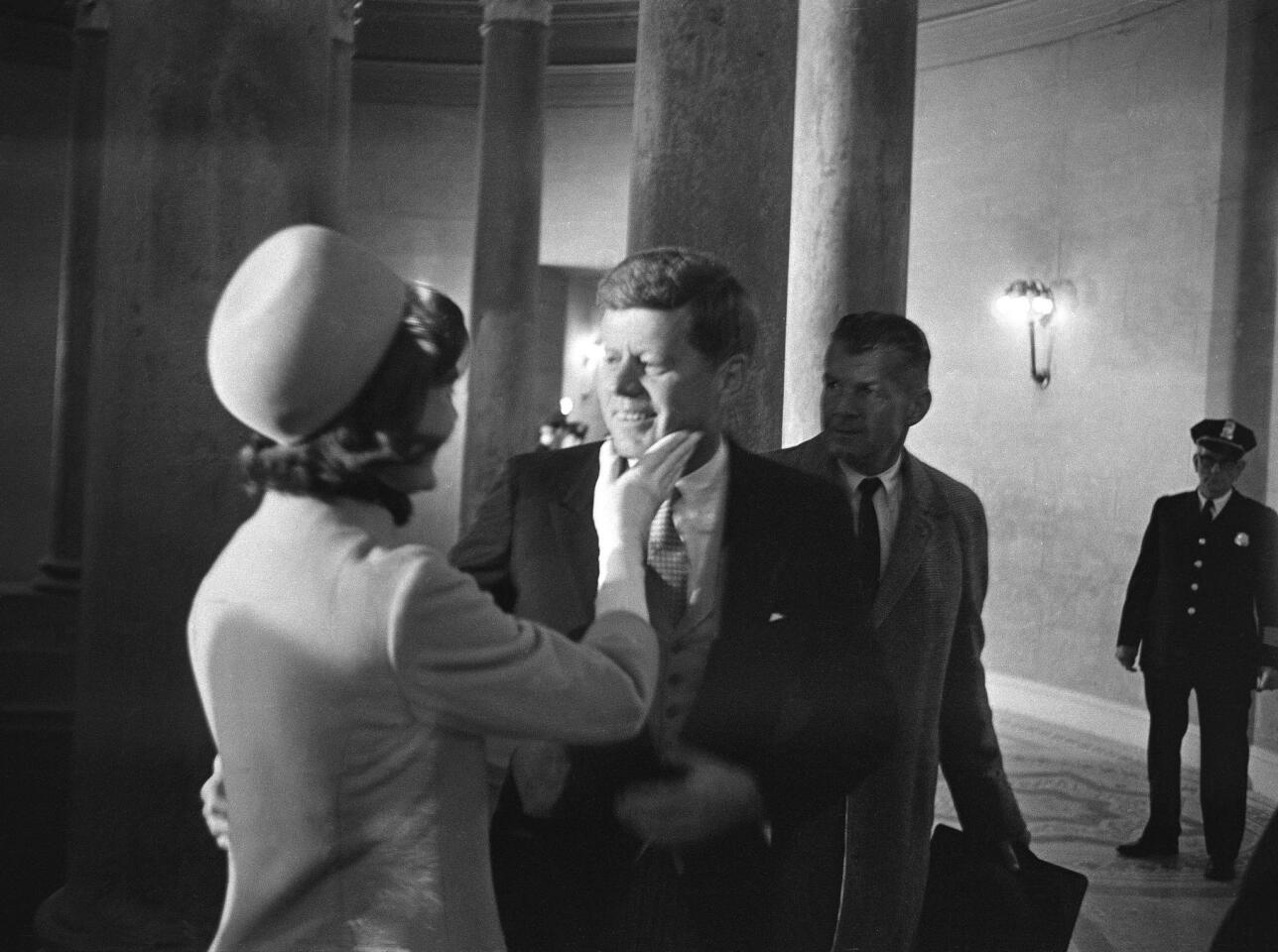 Jacqueline Kennedy, left, caresses her husband's face after he was sworn in as president, the youngest ever elected, on Jan. 21, 1961.