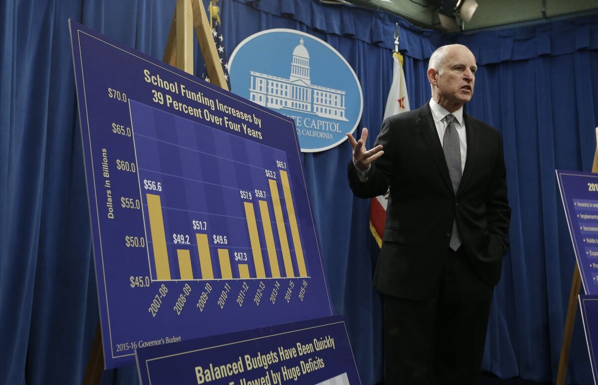Gov. Jerry Brown discusses the increase in school funding in the past four years as he unveils his proposed 2015-16 state budget plan at a Capitol news conference in Sacramento on Friday.