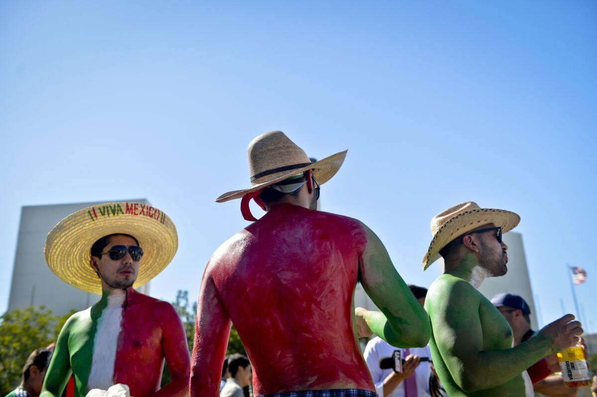 Mexico fans wait for the gates to open at the Los Angeles Memorial Coliseum before Saturday's soccer match between Mexico and Ecuador.