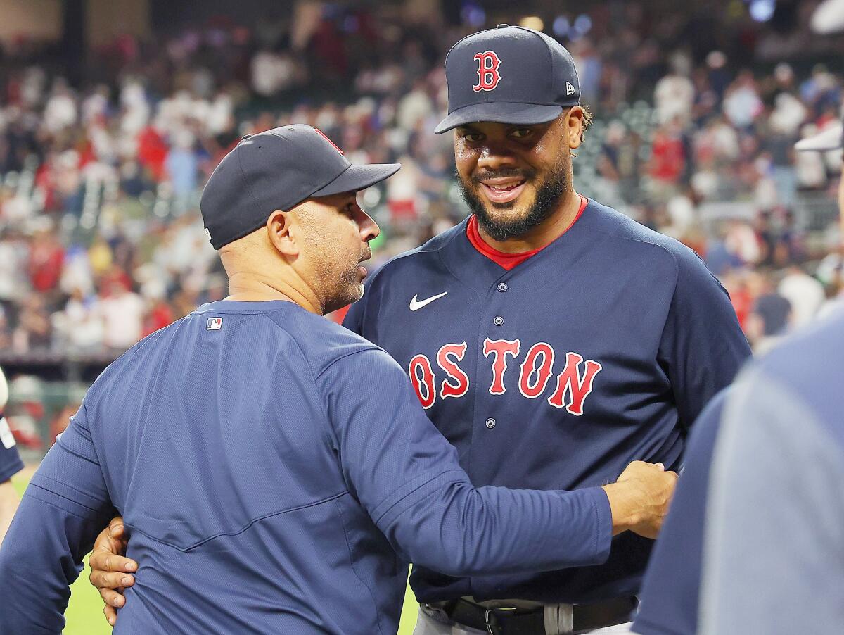 Boston Red Sox's Kenley Jansen celebrates with manager Alex Cora after earning the 400th save of his career.